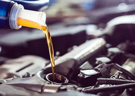 Motor oil being poured into vehicle engine