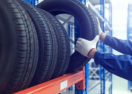 Tire being removed from tire rack